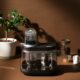 siphonysta automatic coffee maker on a table, surrounded by a plant and some mugs crowdfunding campaign