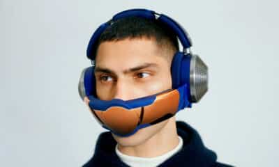 a user wearing the dyson zone headphones with the filtration visor attached against a light background