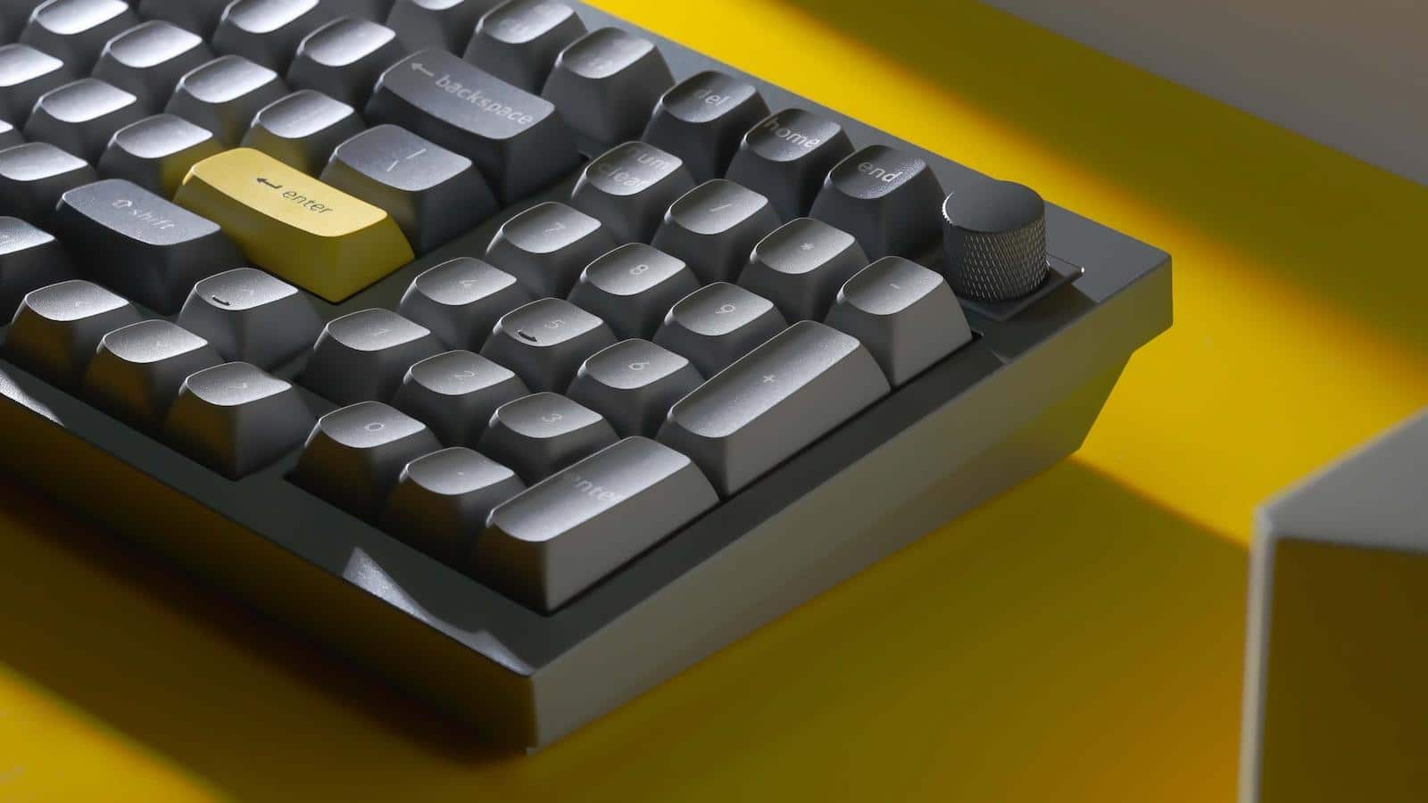 keychron q5 mechanical keyboard on yellow desk