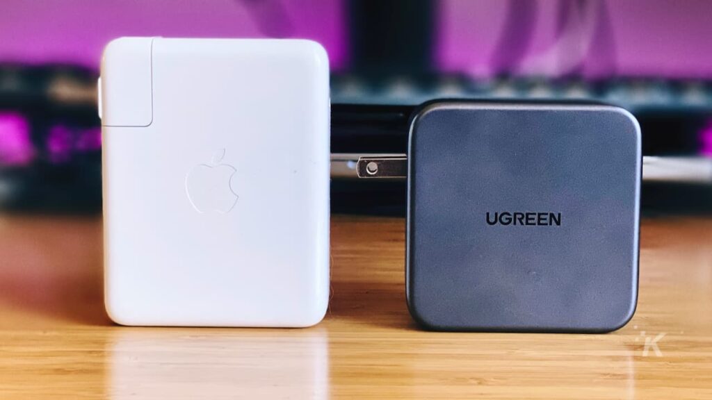 apple usb-c charger vs ugreen usb-c wall charger side by side on office desk