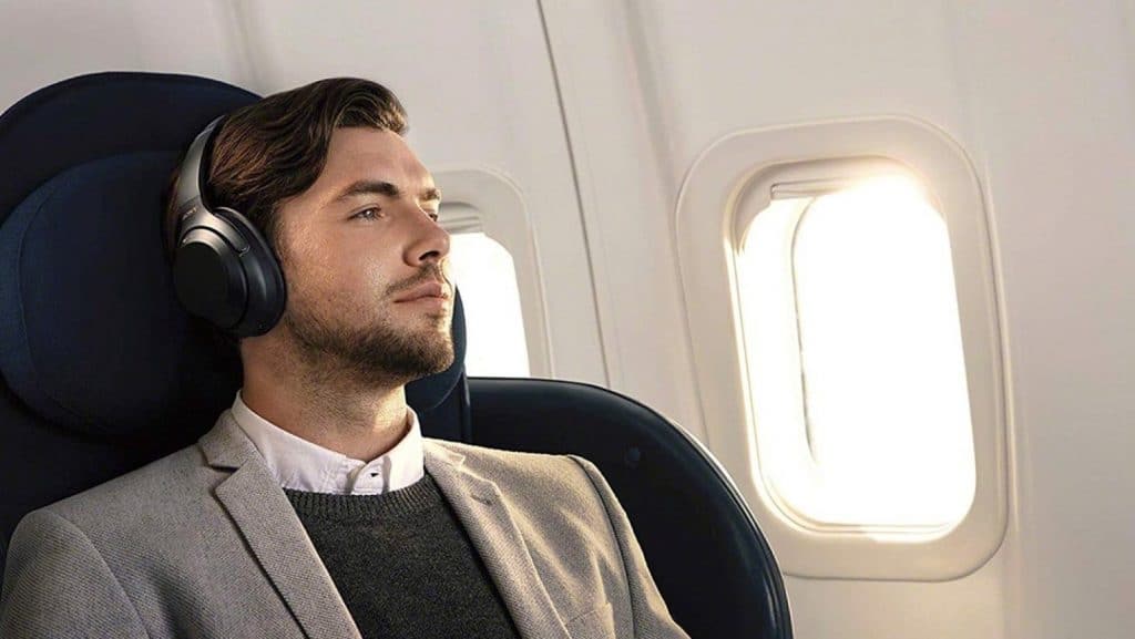 Sony WH-1000XM3 headphones on a guy in a plane
