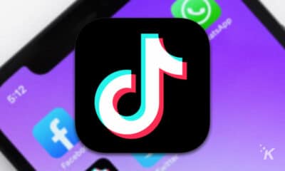 tiktok logo with blurred smartphone in the background