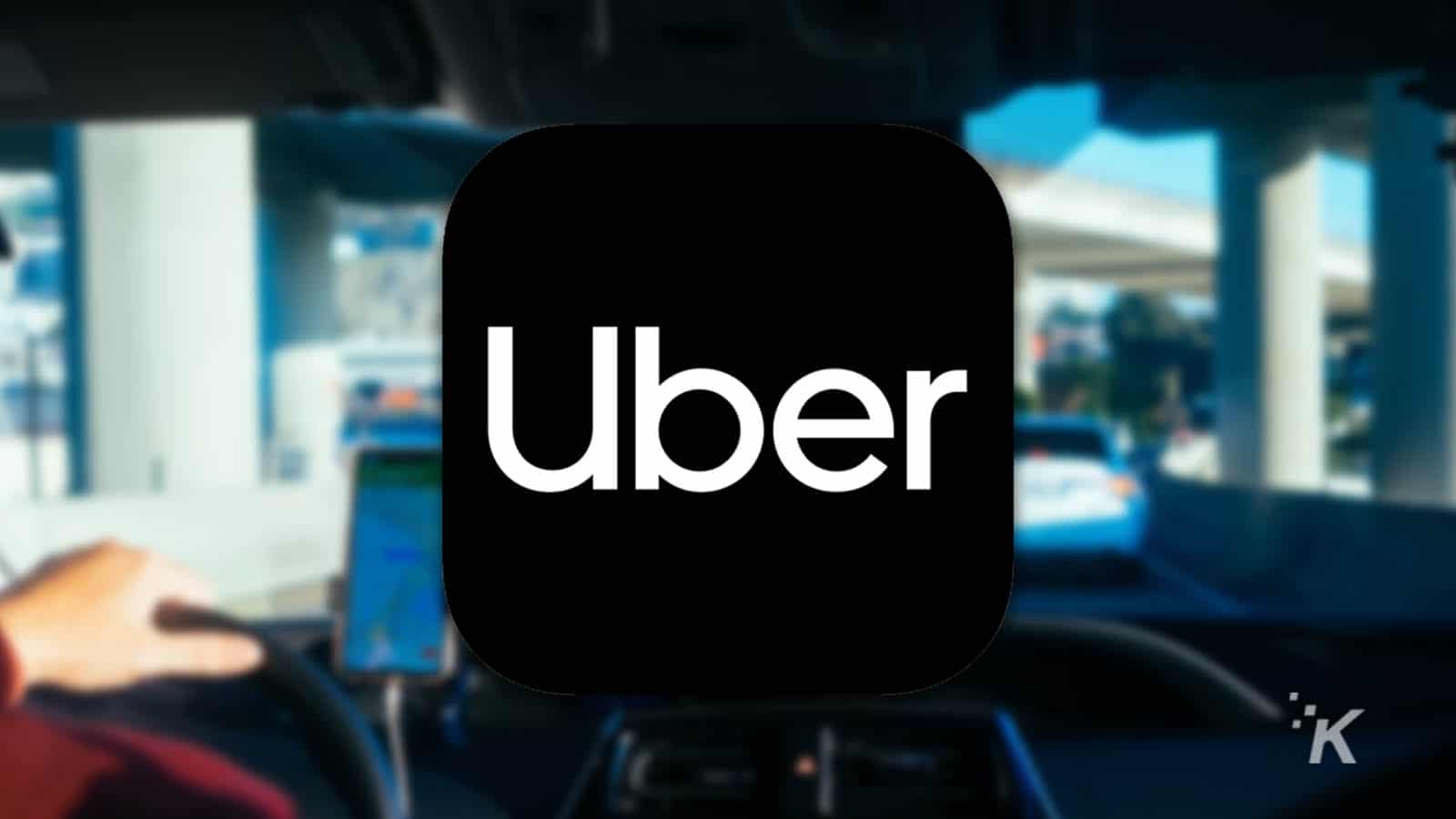 uber logo with blurred background showing driver