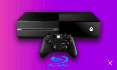 xbox one console and blu ray logo on a purple background