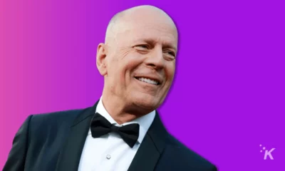 Bruce Willis in a suit on a purple background