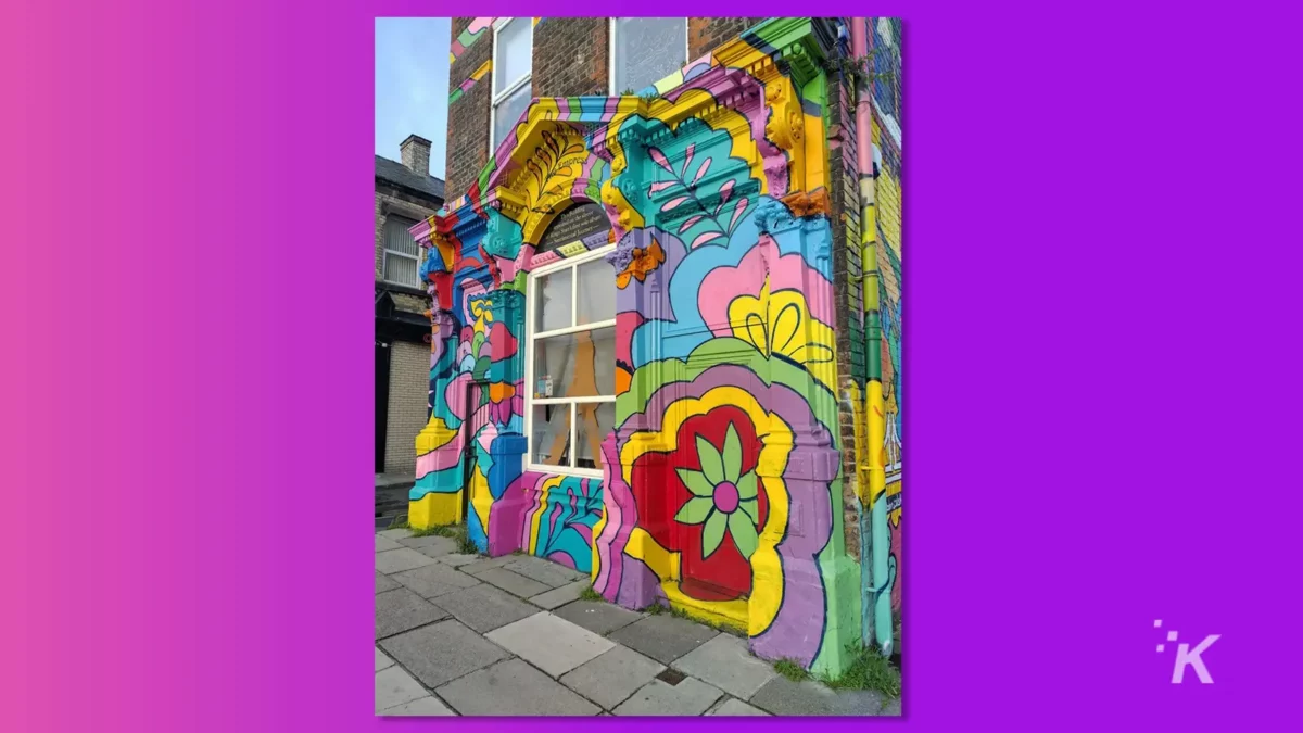 photo of a building with vivid colored graphic artwork of flowers