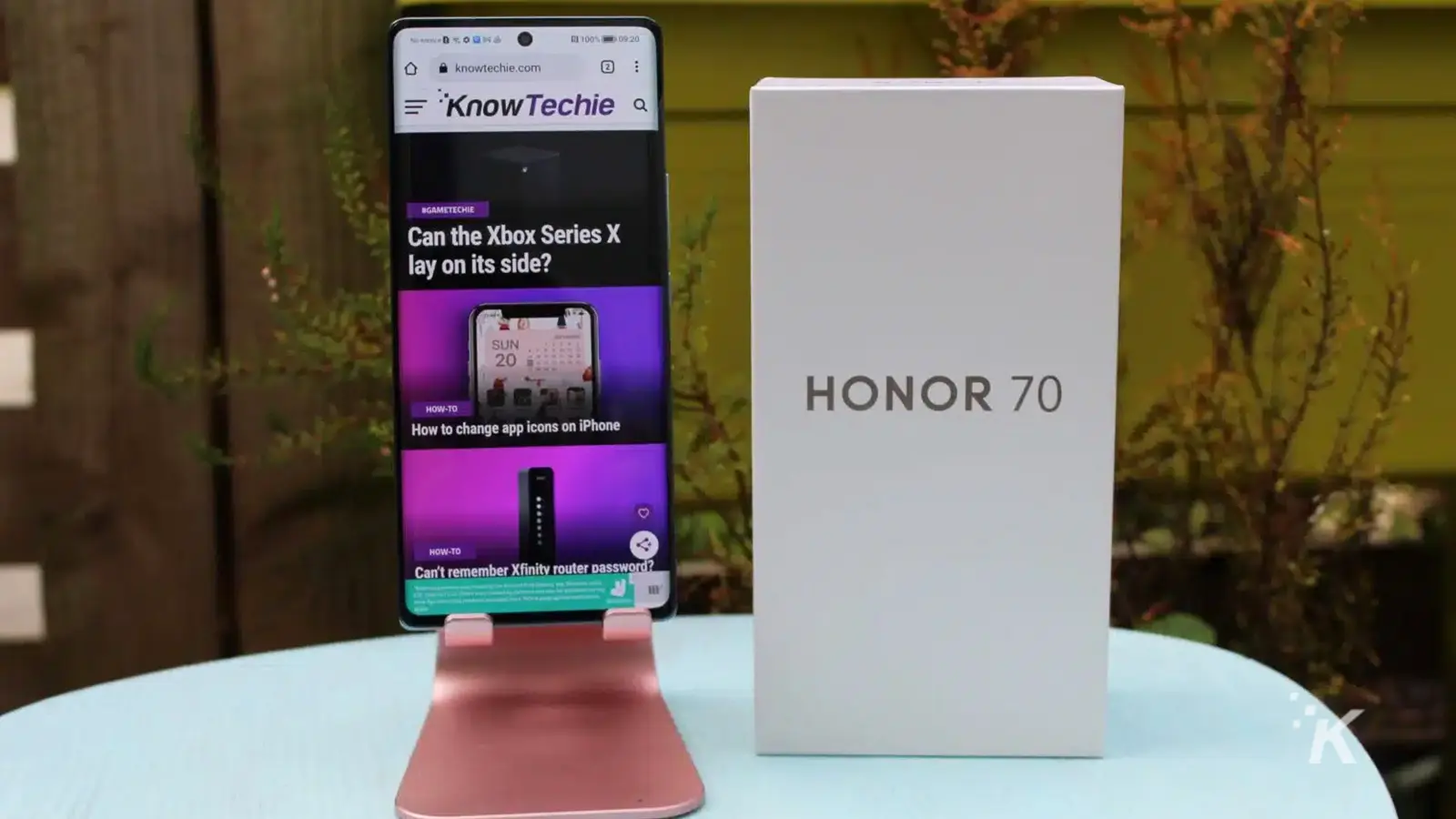 HONOR 70 phone on stand with KnowTechie website openned