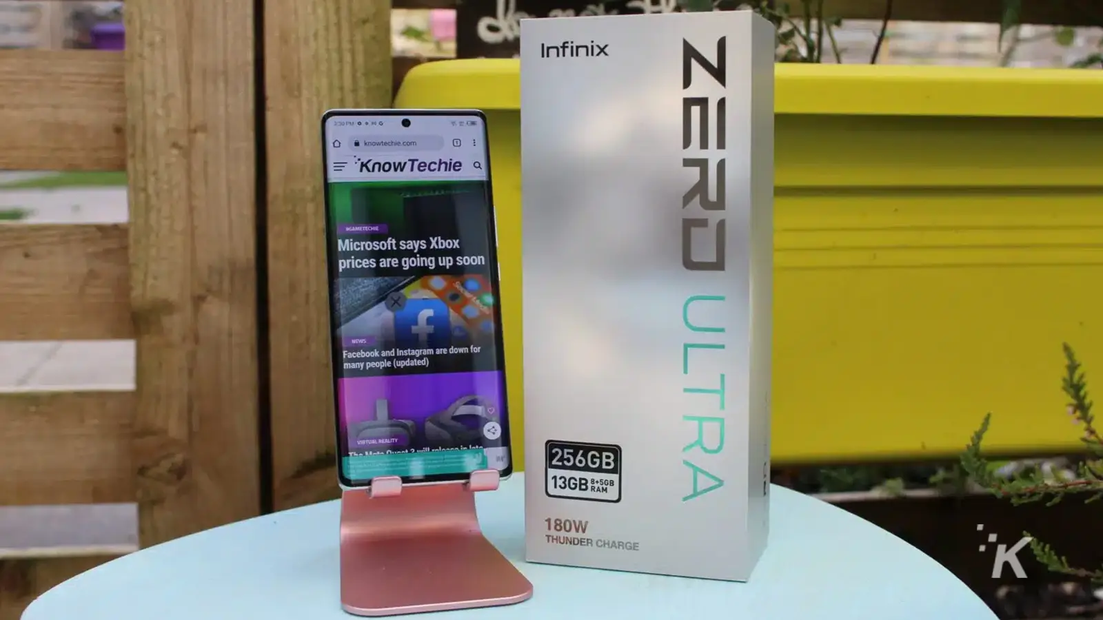 Infinix Zerd Ultra phone on stand next to it's box