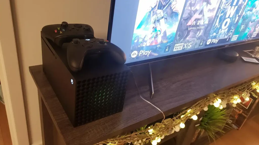 xbox series x laying on side next to TV